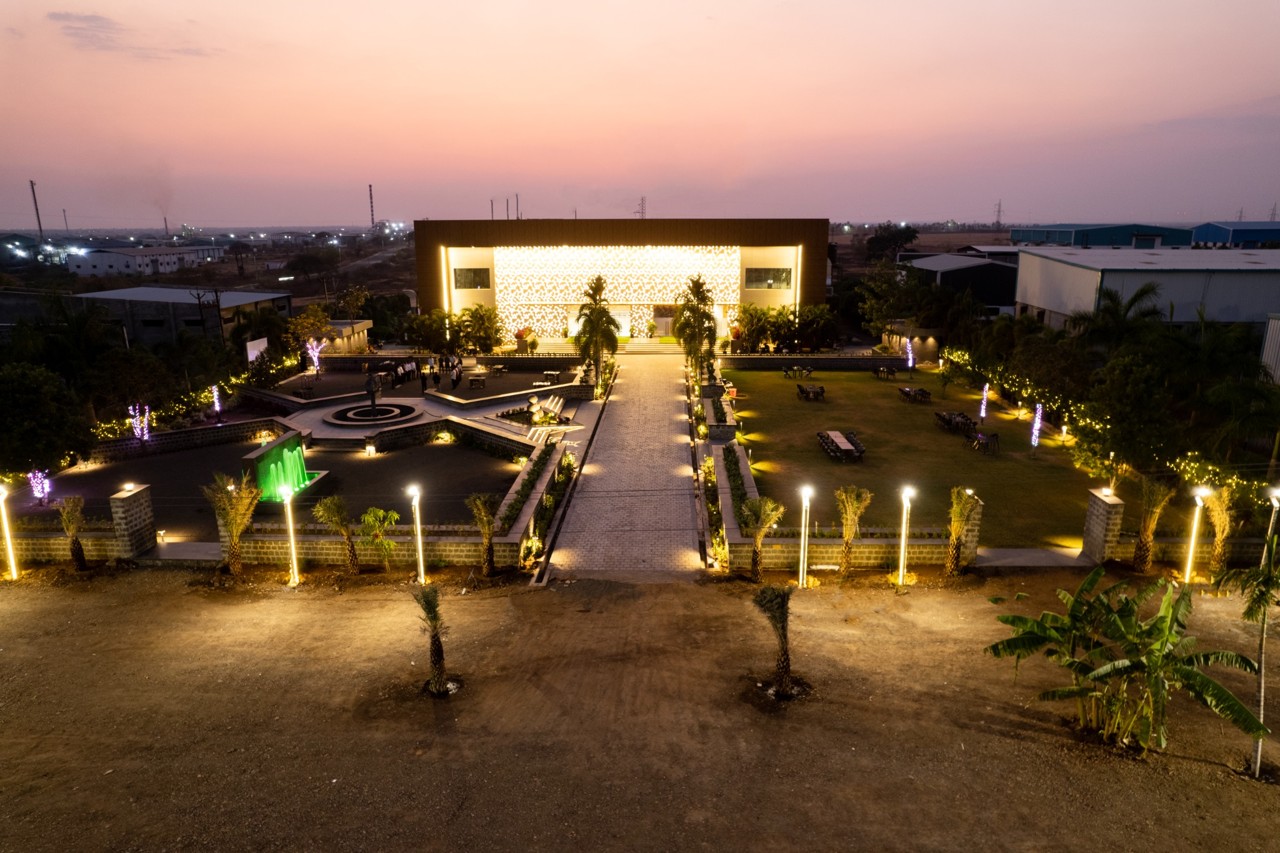 Aerial view of The MB Resort arrival court and illuminated garden at dusk