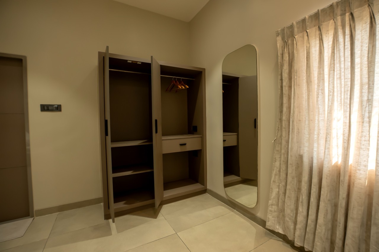 Guest room wardrobe and mirror at The MB Resort