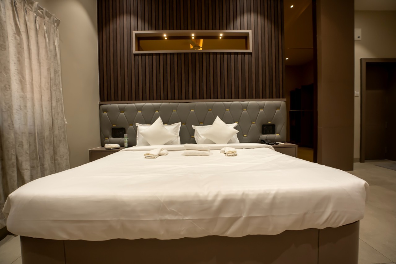 Double bed and headboard at The MB Resort
