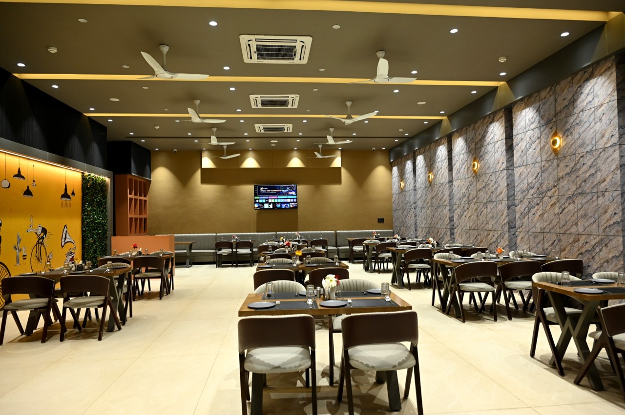 Resort restaurant with dining tables, chairs and wall murals